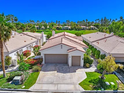a aerial view of a house with a yard and potted plants