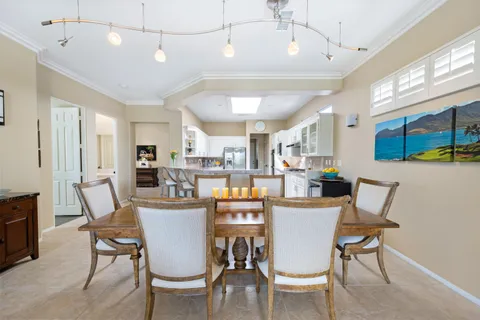 a view of a dining room with furniture and a kitchen