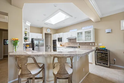 a kitchen with stainless steel appliances granite countertop a stove and a refrigerator