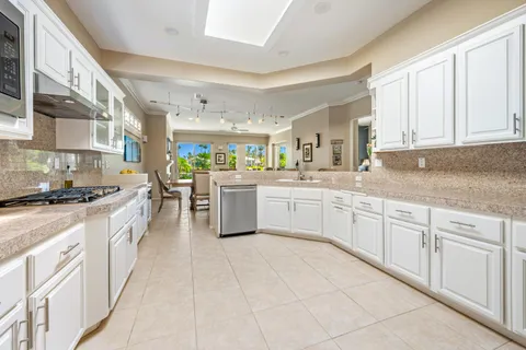 a kitchen with stainless steel appliances granite countertop a sink and cabinets