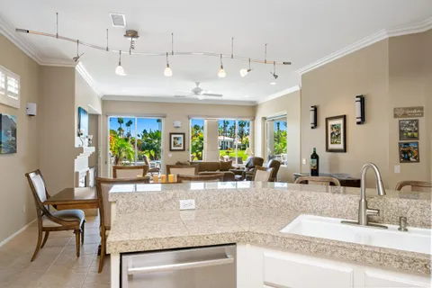 a kitchen with sink and view living room