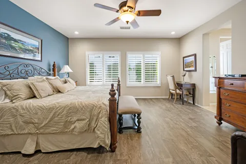 a spacious bedroom with a bed and a table in it