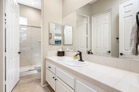 a bathroom with a tub sink and mirror