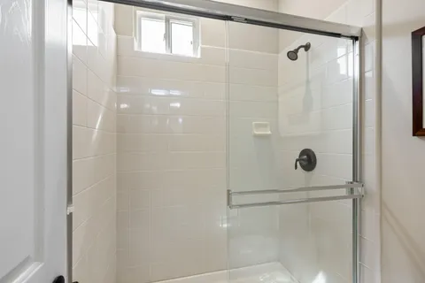 a bathroom with a glass shower door