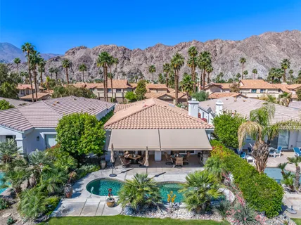 a view of a patio with a table and chairs under an umbrella