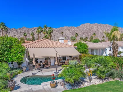a view of a house with outdoor space and sitting area