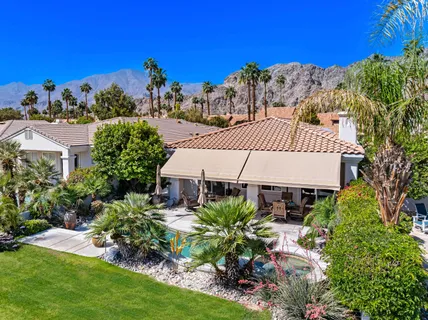 view of a house with a yard and sitting area