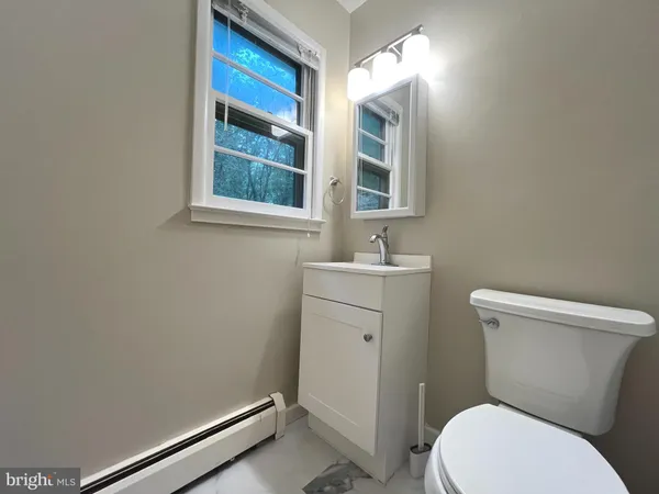 a bathroom with a toilet sink and window