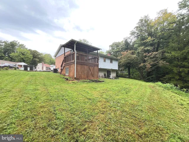 a view of a house with a yard and sitting area