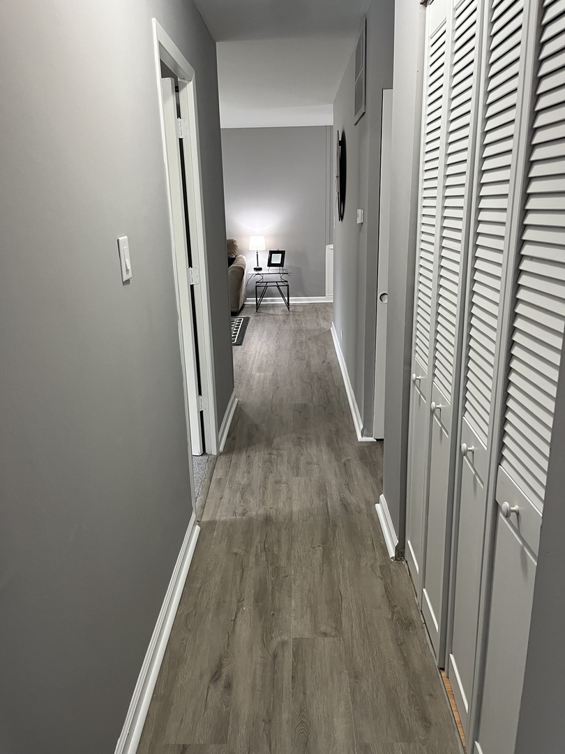 207 MacGregor Road Lockport, IL 60441 - Photo 12 of 14 a view of a hallway with wooden floor and staircase
