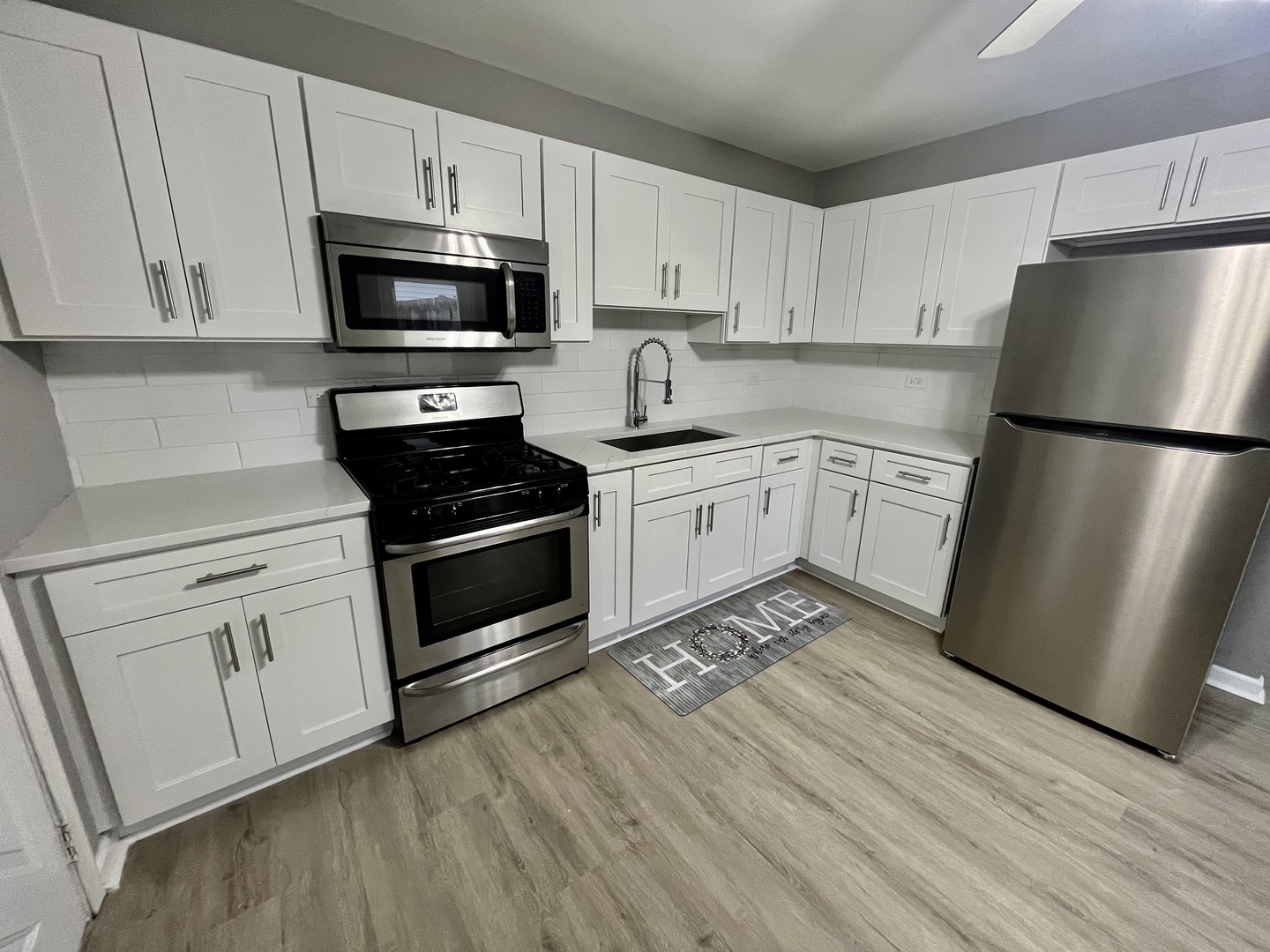 207 MacGregor Road Lockport, IL 60441 - Photo 6 of 14 a kitchen with a refrigerator stove and white cabinets