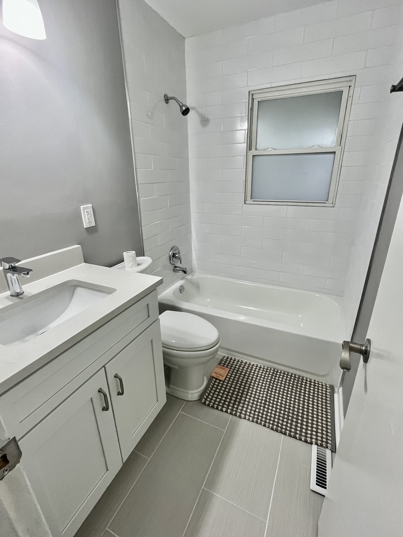 207 MacGregor Road Lockport, IL 60441 - Photo 9 of 14 a bathroom with a sink a toilet and shower