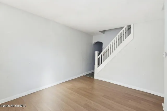 a view of an entryway with wooden floor