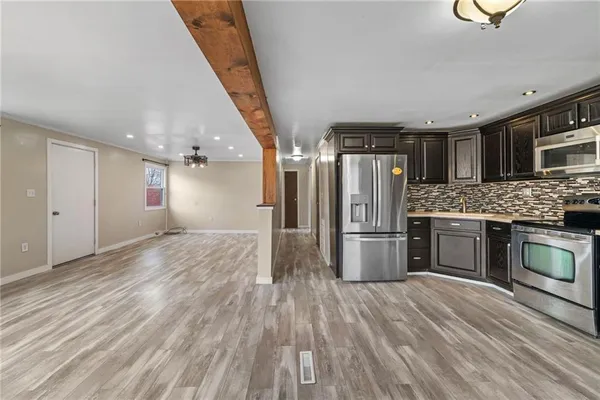 a kitchen with a refrigerator and a sink