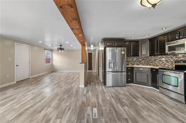 a kitchen with a refrigerator and a sink