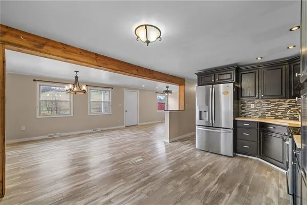 a kitchen with stainless steel appliances granite countertop a stove and a sink