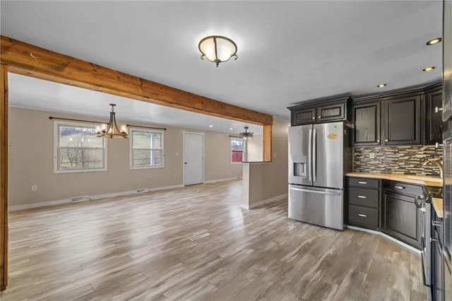 a kitchen with stainless steel appliances granite countertop a stove and a sink