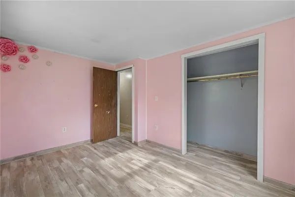 a view of empty room with wooden walls