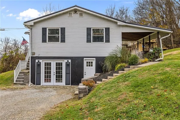 a front view of a house with a yard and porch