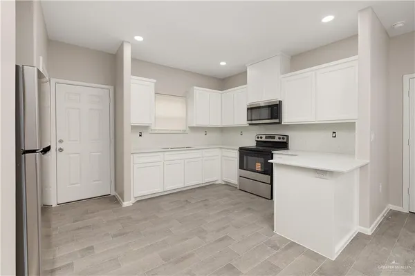 a kitchen with a sink stainless steel appliances and cabinets