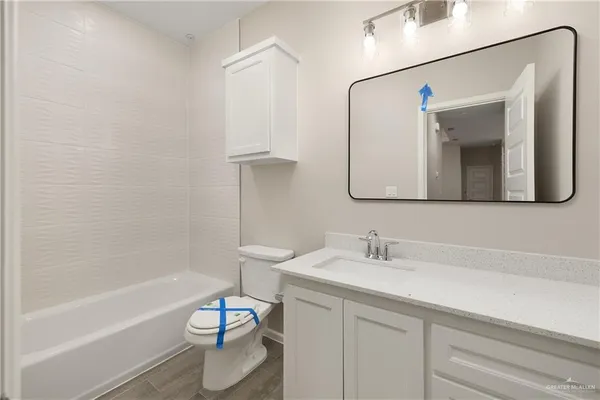 a bathroom with a sink a toilet and bathtub