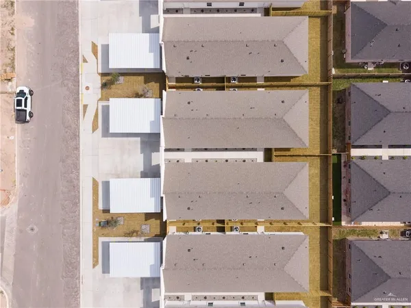 an aerial view of residential houses with outdoor space