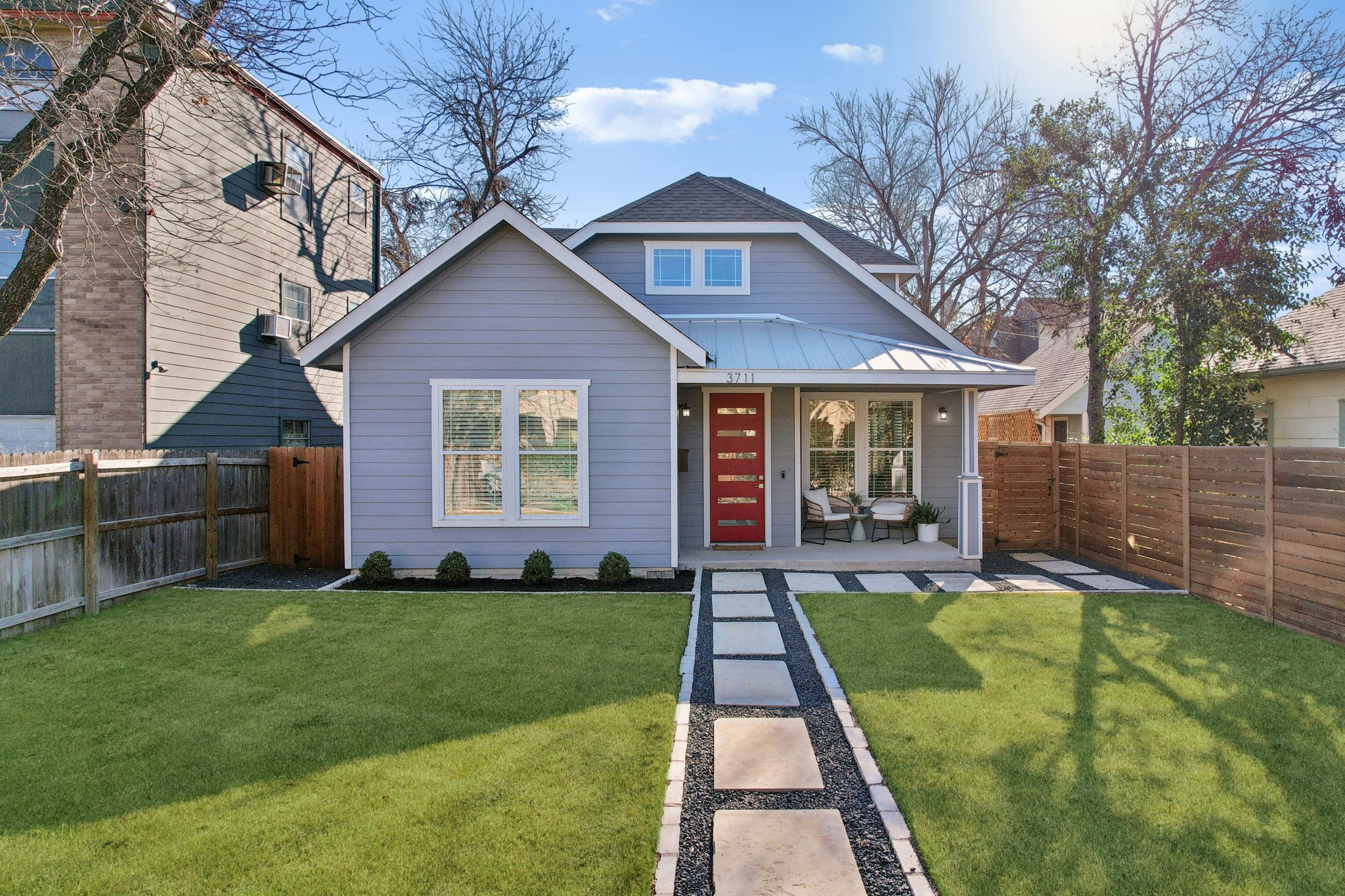a view of a house with a yard and porch