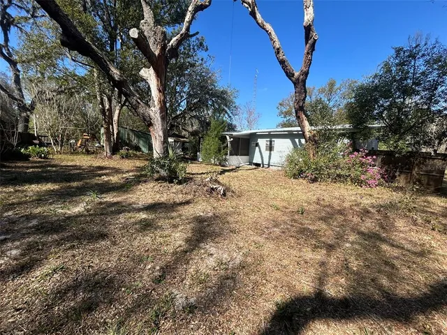 a backyard of a house with table and chairs