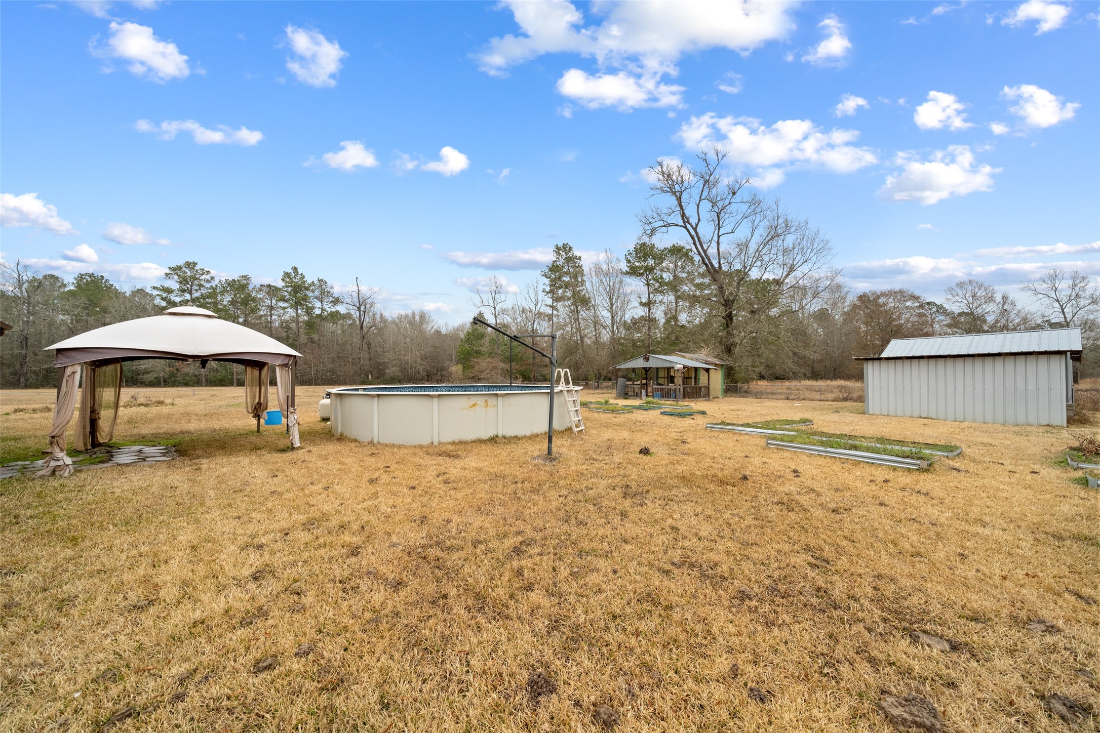 31 Shady Lane Shepherd, TX 77371 - Photo 20 of 31 a backyard of a house with table and chairs