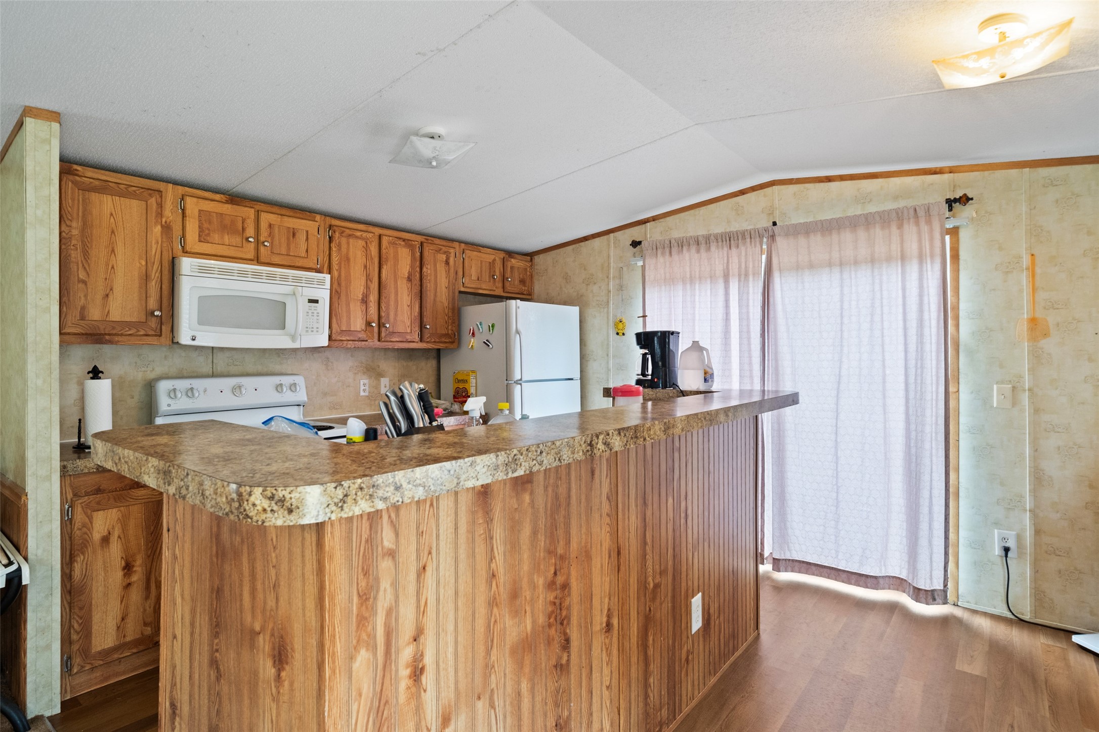 31 Shady Lane Shepherd, TX 77371 - Photo 24 of 31 a kitchen with stainless steel appliances granite countertop a refrigerator a sink dishwasher and wooden cabinets with wooden floor