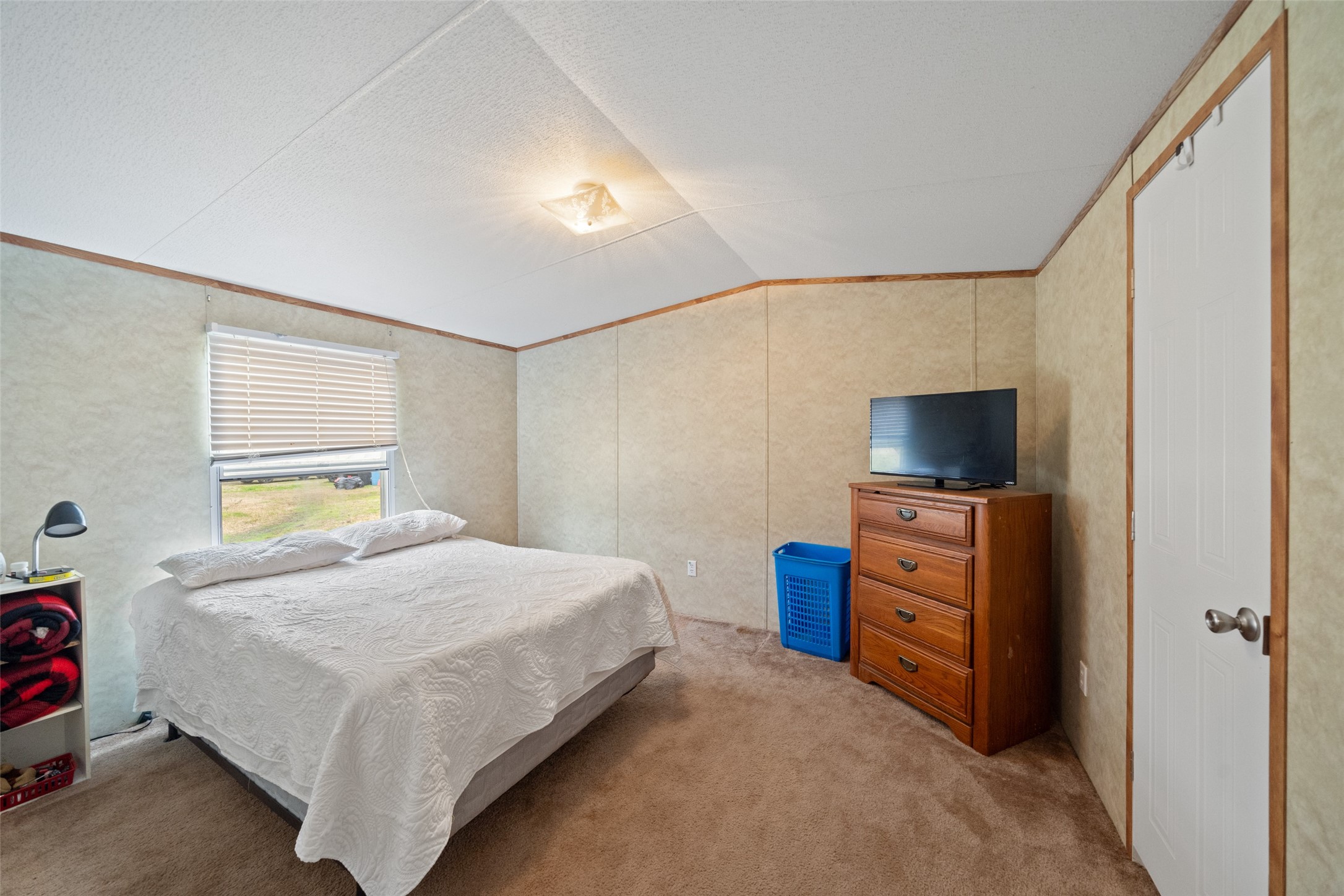 31 Shady Lane Shepherd, TX 77371 - Photo 26 of 31 a bedroom with a bed and flat screen tv