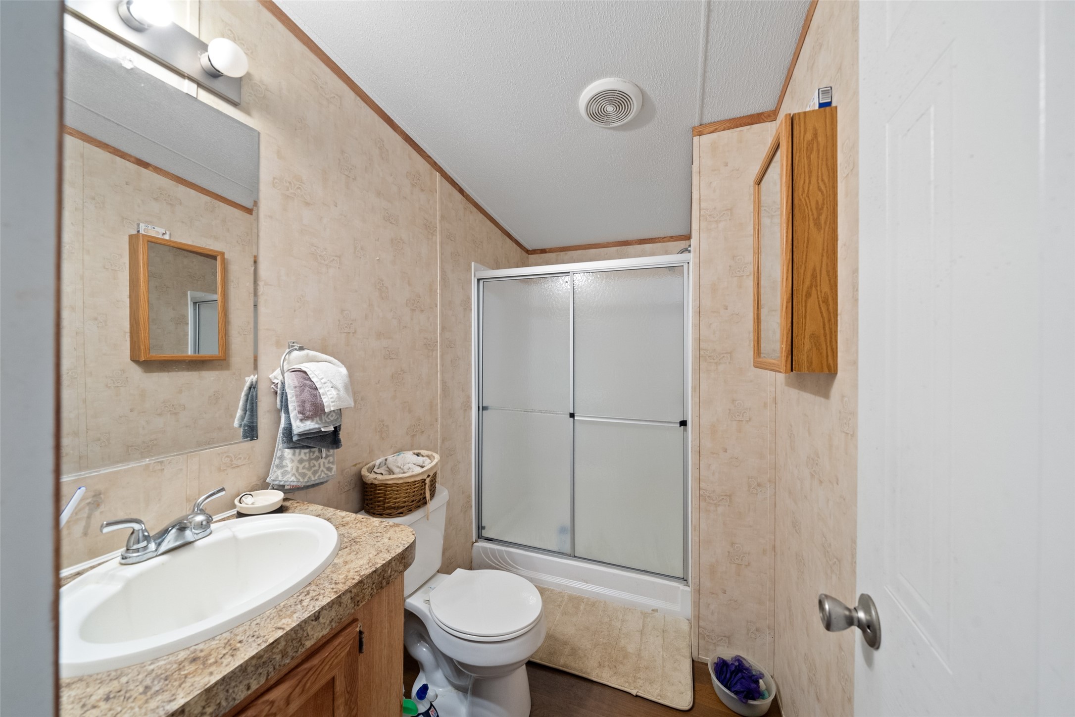 31 Shady Lane Shepherd, TX 77371 - Photo 27 of 31 a bathroom with a granite countertop sink toilet and shower