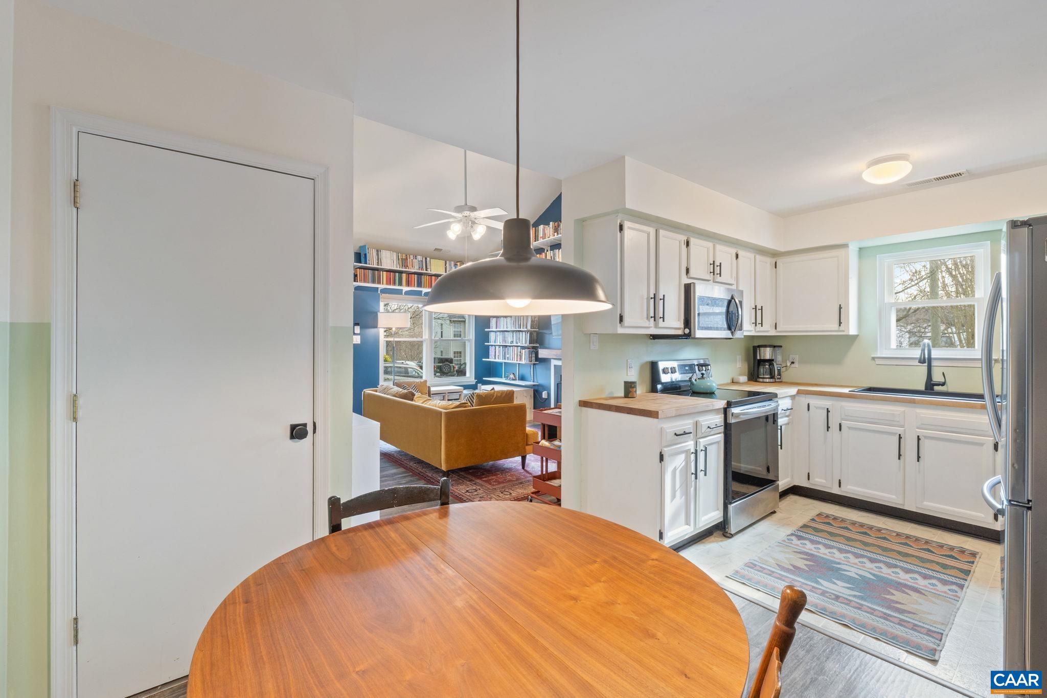 401 Riverside Avenue Charlottesville, VA 22902 - Photo 11 of 36 a open kitchen with stainless steel appliances granite countertop a stove a sink dishwasher and a refrigerator with wooden floor