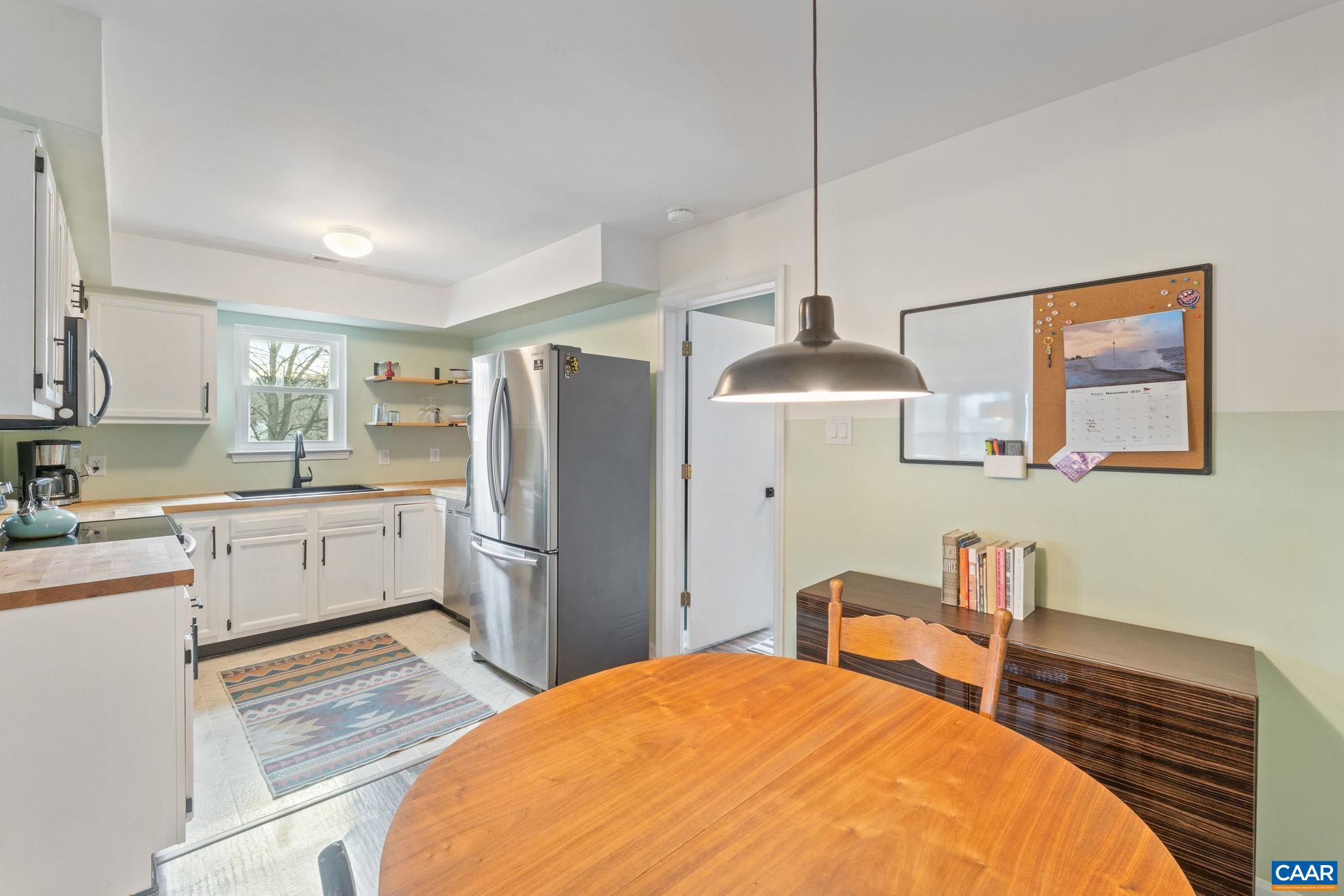 401 Riverside Avenue Charlottesville, VA 22902 - Photo 10 of 36 a kitchen with a refrigerator and a wooden floor