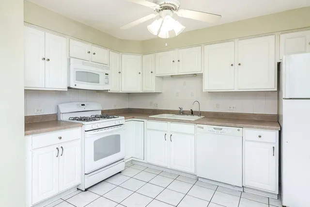 a kitchen with cabinets appliances and a sink