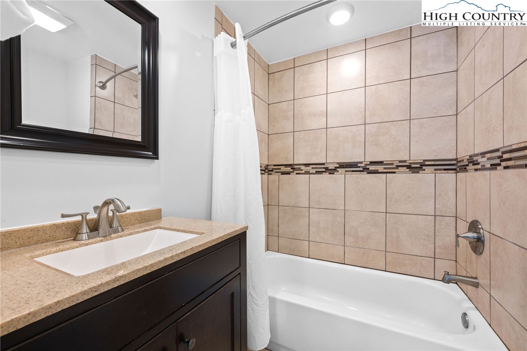 109 Skiloft Road Beech Mountain, NC 28604 - Photo 17 of 30 a bathroom with a sink and a mirror