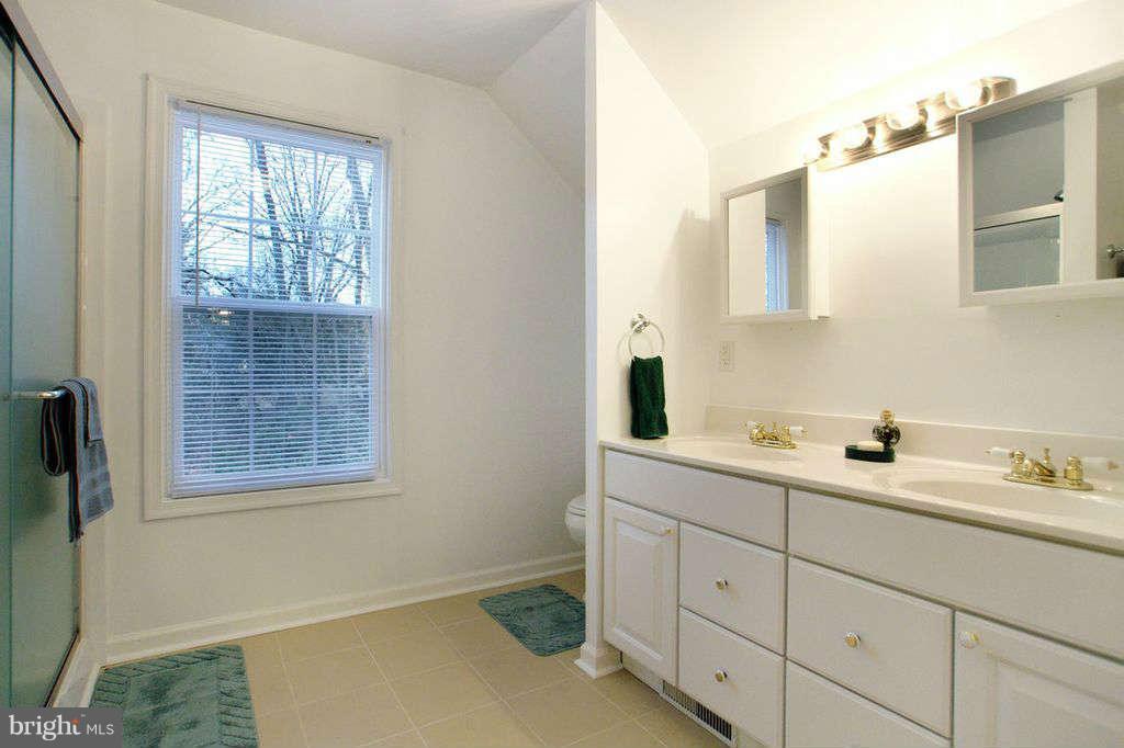 1010 Bernoudy Road White Hall, MD 21161 - Photo 19 of 28 a bathroom with a double vanity sink and mirror with window