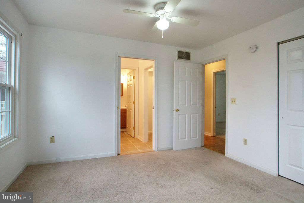 1010 Bernoudy Road White Hall, MD 21161 - Photo 23 of 28 an empty room that has a window and a ceiling fan