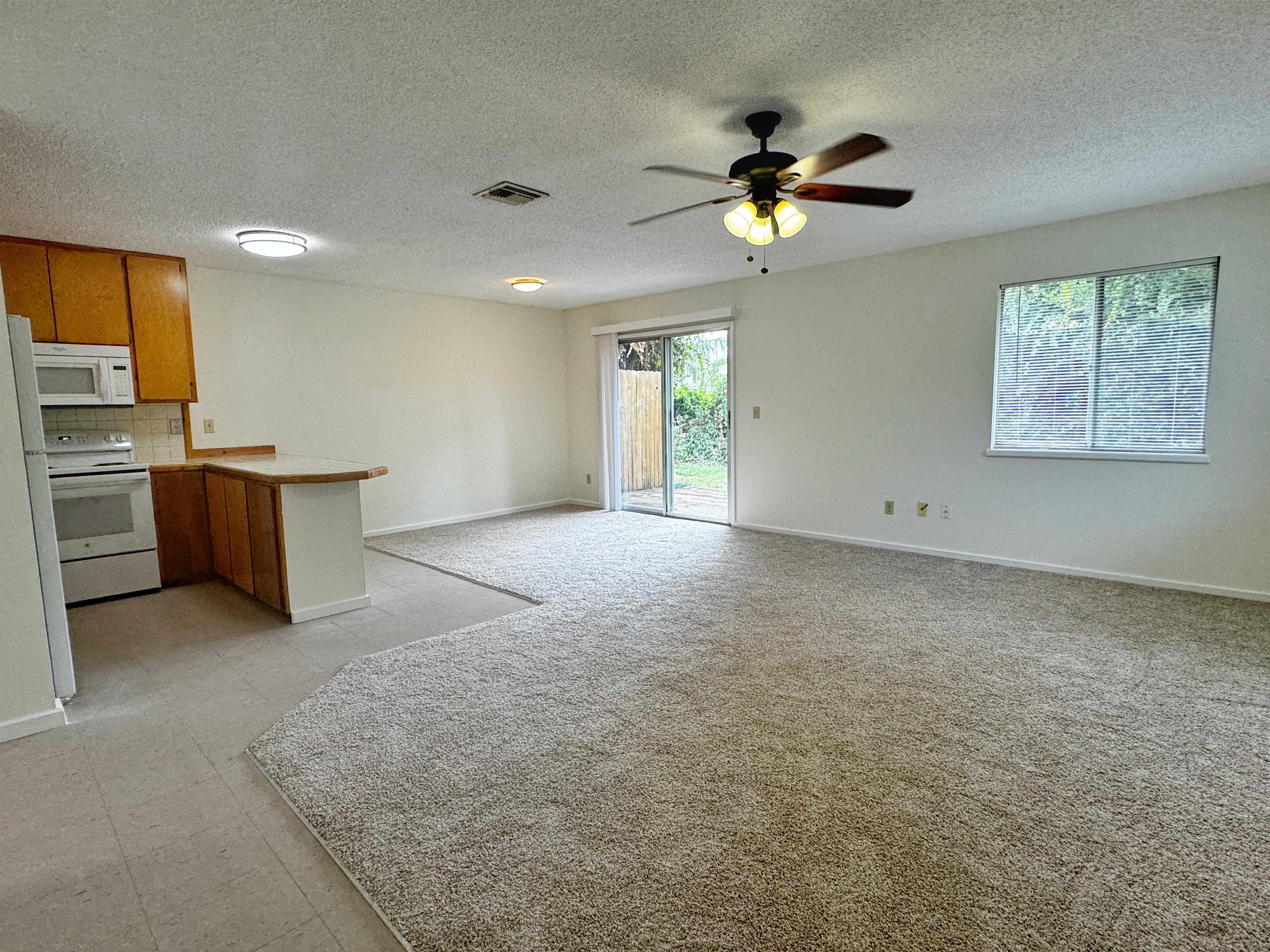 204 8th Street, Unit A St. Augustine, FL 32080 - Photo 2 of 15 a view of a livingroom with a ceiling fan and window