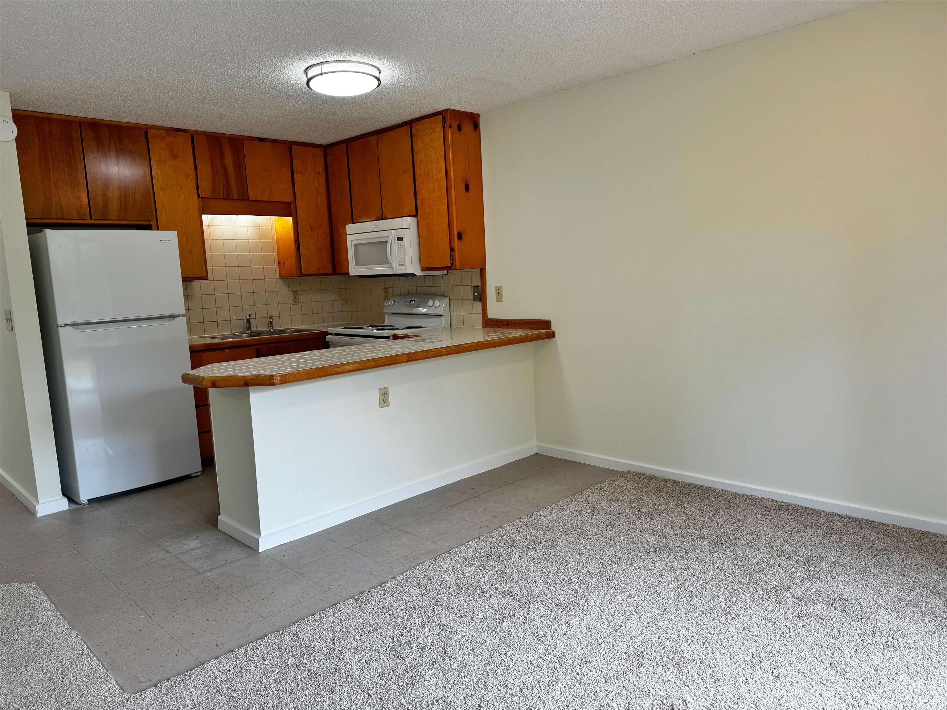 204 8th Street, Unit A St. Augustine, FL 32080 - Photo 4 of 15 a kitchen with a refrigerator sink and cabinets