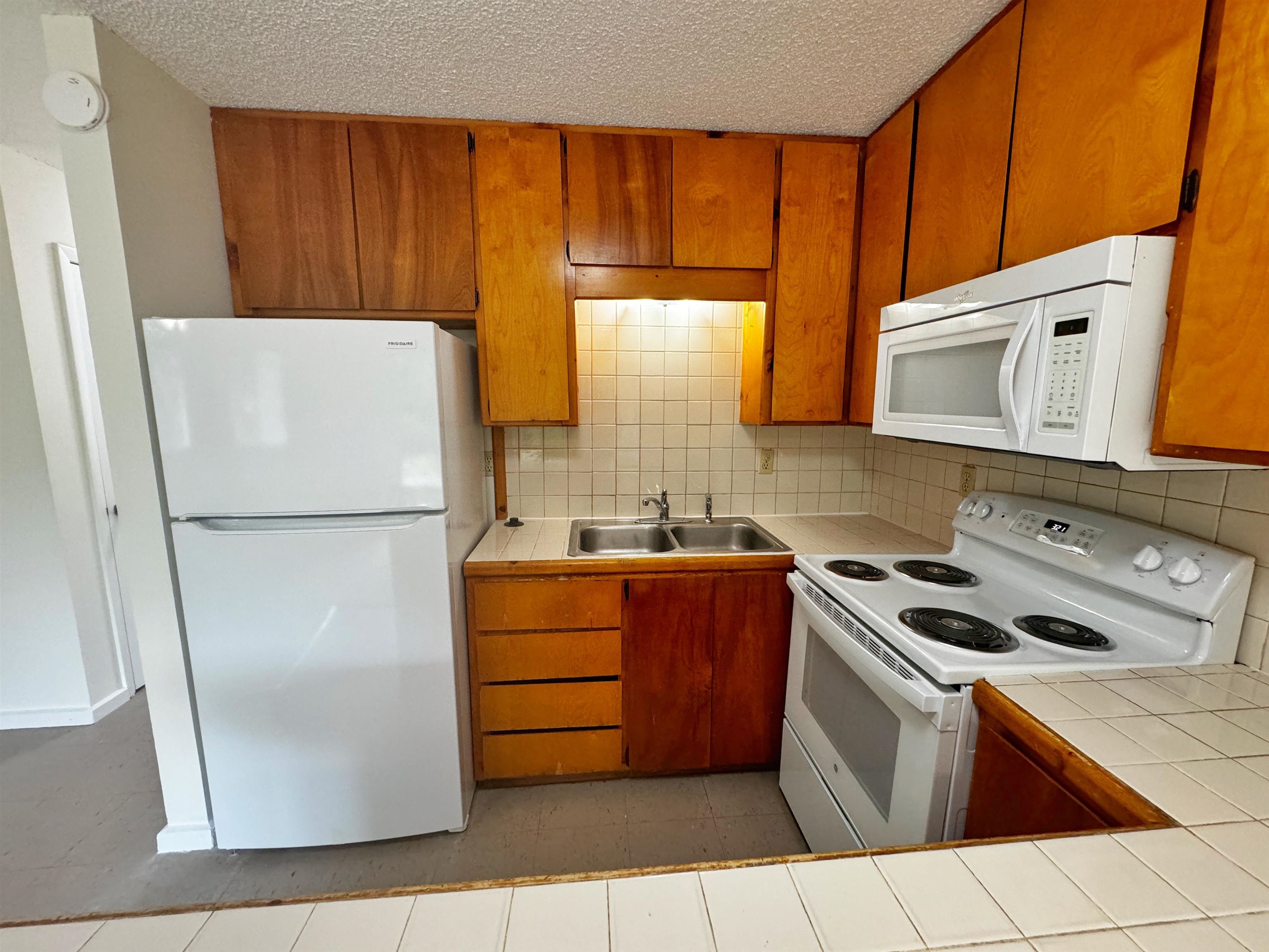 204 8th Street, Unit A St. Augustine, FL 32080 - Photo 7 of 15 a kitchen with stainless steel appliances granite countertop a refrigerator a stove a sink and a microwave