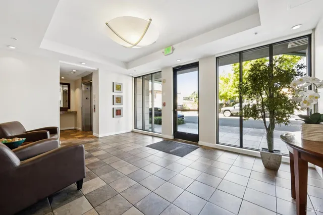 a view of a livingroom with furniture and floor to ceiling window
