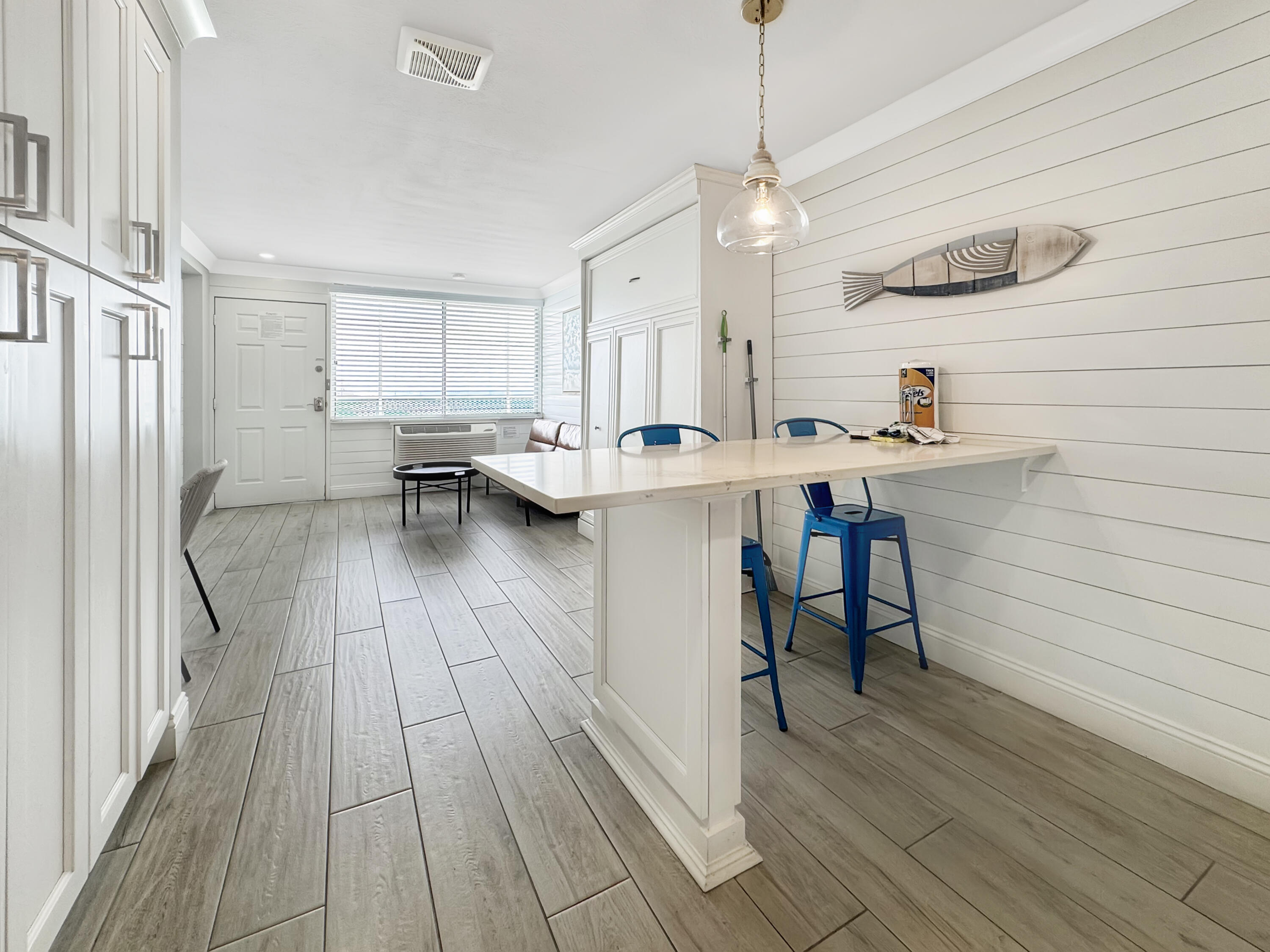 14401 Front Beach Road, Unit 221 Panama City Beach, FL 32413 - Photo 9 of 20 a kitchen with a sink and wooden floor
