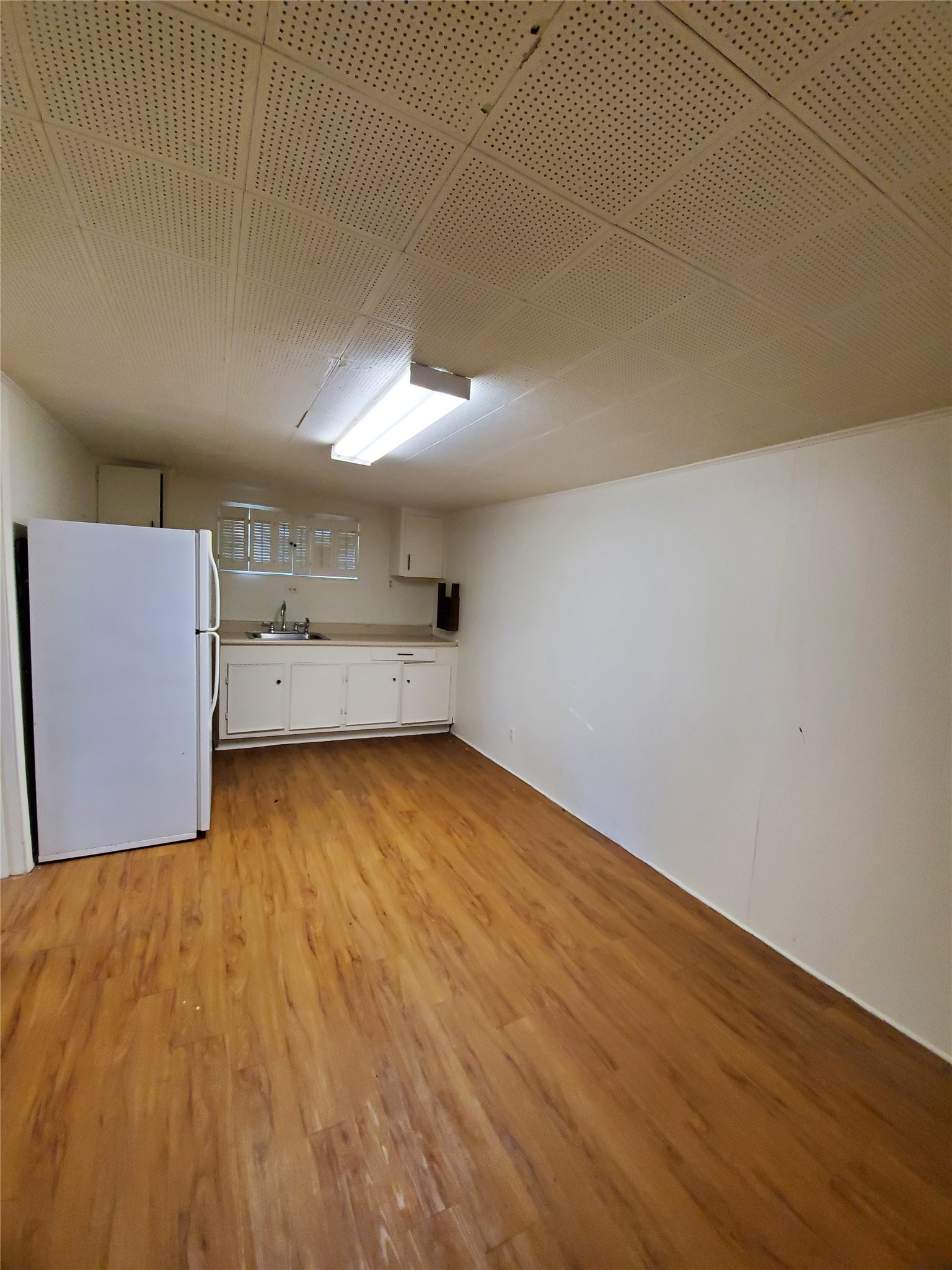 4113 Speedway Austin, TX 78751 - Photo 25 of 31 Functional kitchen space featuring practical cabinetry and warm wood-look flooring.