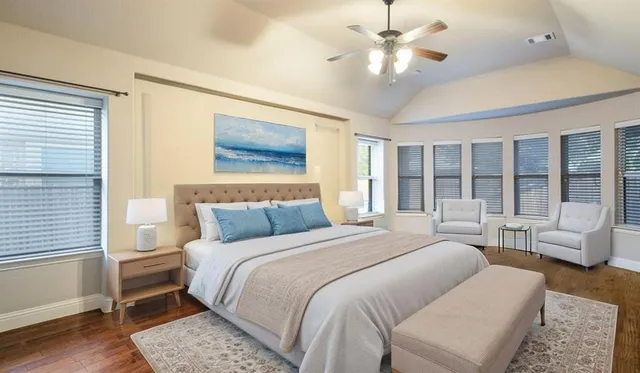 a bedroom with a large bed couch and a window