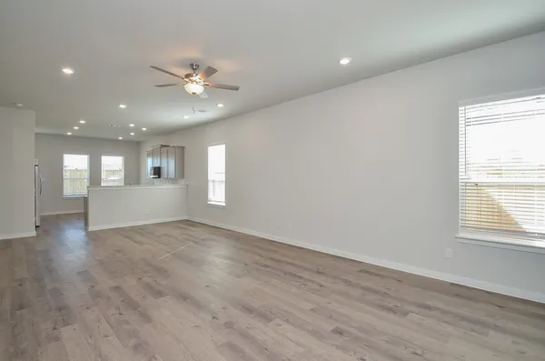 a view of an empty room with wooden floor
