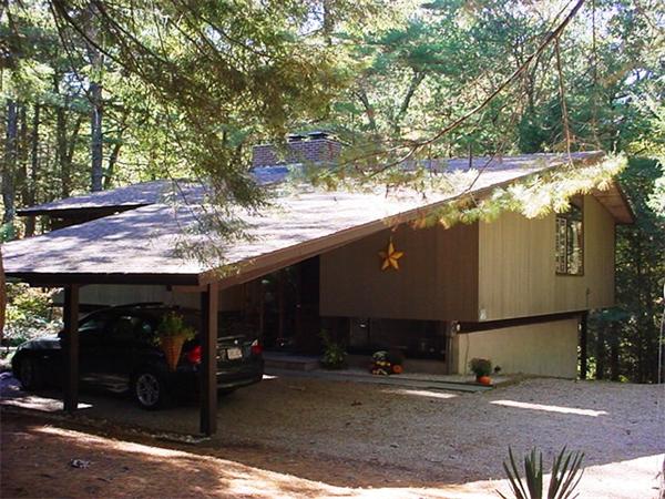 a view of a house with a tree beside it