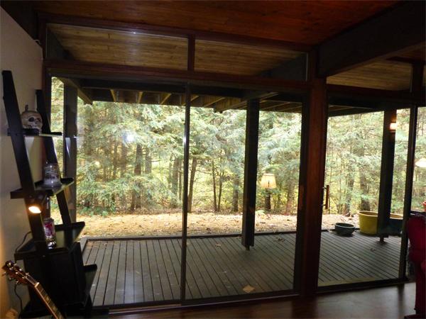 25 Belvedere Road Boxford, MA 01921 - Photo 13 of 16 a living room with large trees and a wooden floor