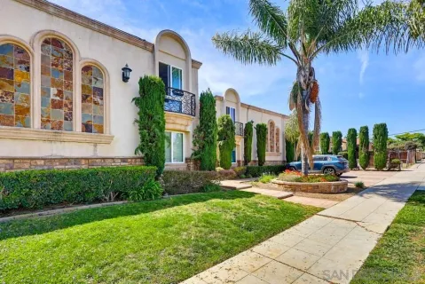 a view of a house with palm trees