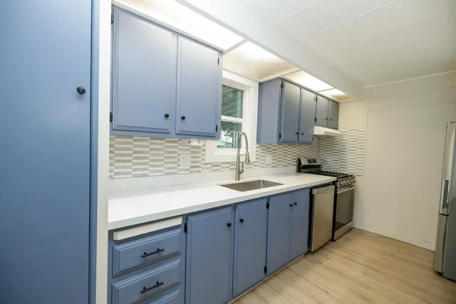 a kitchen with a sink and cabinets